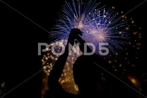 New Year concept - cheering crowd and fireworks Stock Photos