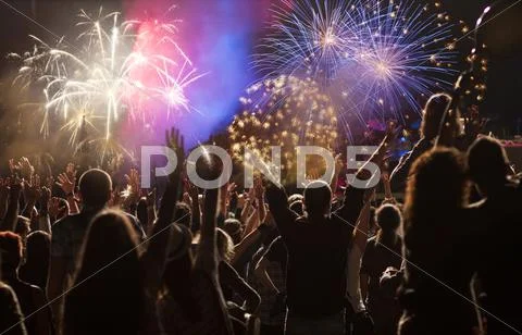 New Year concept - cheering crowd and fireworks Stock Photos