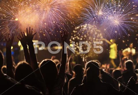 New Year concept - cheering crowd and fireworks Stock Photos