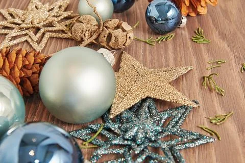 New Year decor scattered on the table with blue toy balls, stars and cones Stock Photos