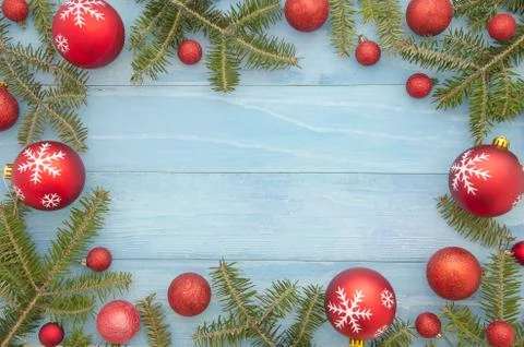 New year decorations frame with red balls decor and fir tree. on light blue Stock Photos