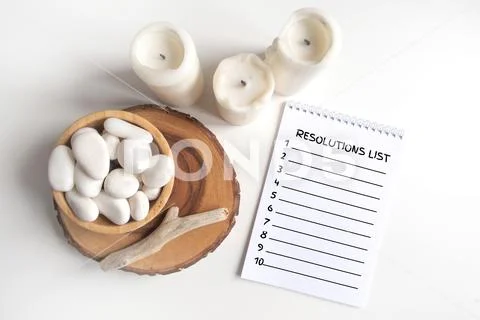 New Year empty resolutions list with a bowl of white pebble and white candles PSD Template