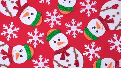 New year figures of snowmen rotate on red background with snowflakes.top view.4k Stock Footage 219935528
