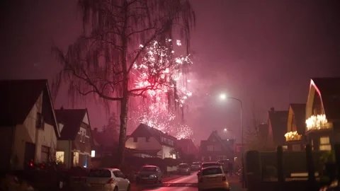 New Year Fireworks Exploding Over Neighborhood Street in Oosterbeek Stock Footage 327712004