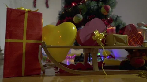 New year gift boxes under Christmas tree in decorated room, crane shot, tilt up. Stock Footage 100033686