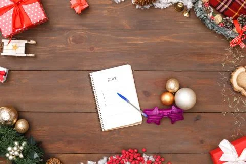 New Year Goals. Objects planner fancy glasses and baubles on table top view Stock Photos