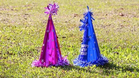The New Year party hat is placed on a bright green grass with a gentle blow Stock Footage 121429014