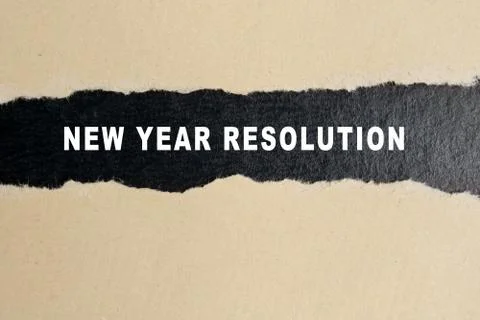 New year resolution words on torn paper background. Stock Photos
