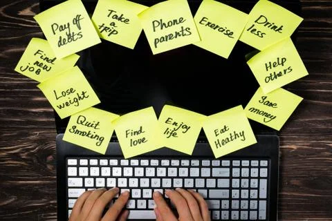 New year resolutions concept - resolutions on post-it notes on notebook screen Stock Photos