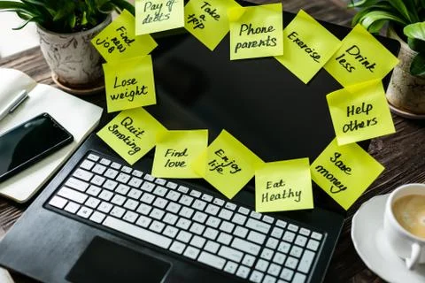 New year resolutions concept - resolutions on post-it notes on notebook screen Stock Photos