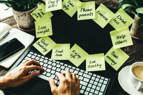 New year resolutions concept - resolutions on post-it notes on notebook screen Stock Photos