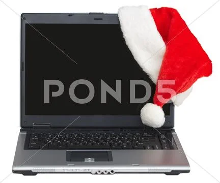 New year s laptop with blank screen and santa cap Stock Photos