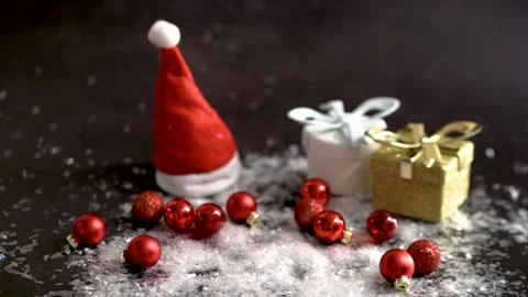 The new year  stand on snow next to scattered red balls of Christmas decorations Stock Footage 143822281
