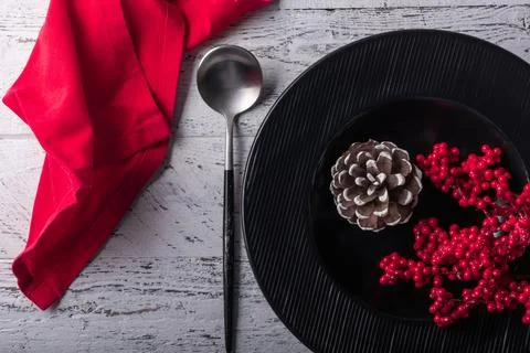 New Year table setting with a black plate with decorative traditional Christm Stock Photos
