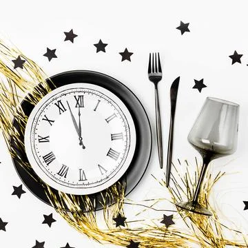 New Year table setting. Black tableware and decoration. Flat lay, top view. Stock Photos