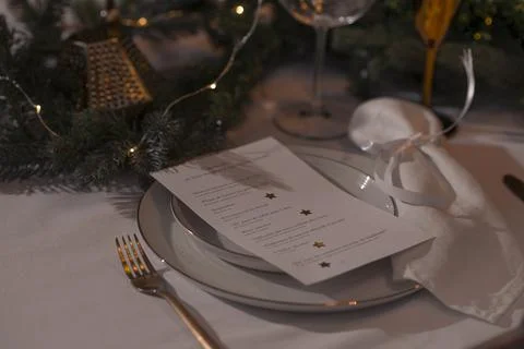 New Year table setting with lantern candles, festive tableware and calligraphy Stock Photos