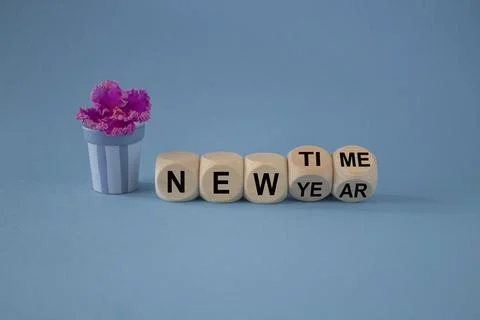 New year time. Turned a cube and changed the words new year to new time. Stock Photos