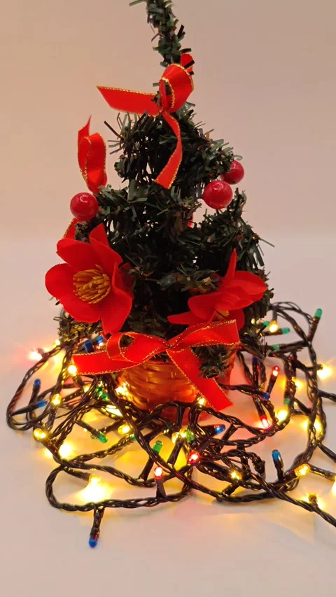 New Year tree with a bow on a white background with multi-colored twinkling ligh Stock Footage 322539808