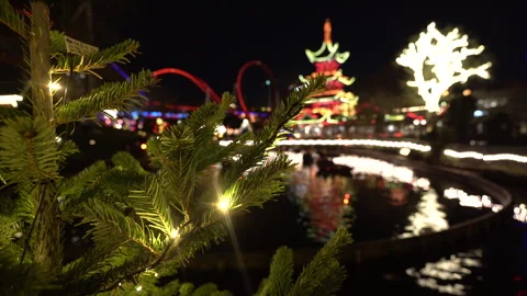 New Year tree branches against the backdrop of an amusement park. Stock-Footage 262694610