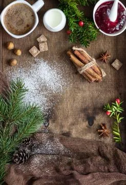 New year tree branches, cones, spices and coffee. Holiday breakfast. Stock Photos