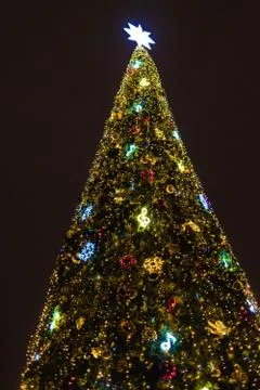 New year tree, decorated with classical toys and illuminated with led lights Stock Photos