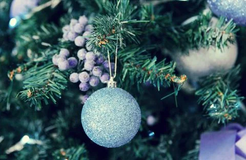New Year tree decorated with violet and shiny toys Stock Photos
