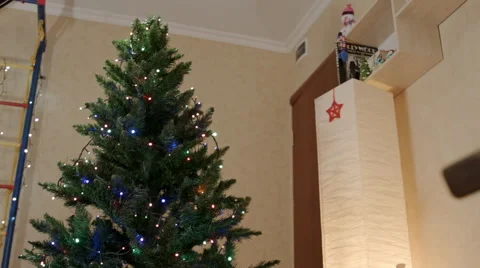 New year tree with lamp garlands in the center of the living room 스톡 동영상 67828876