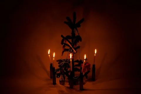 New Year tree with pine cones, garland, Ukrainian flag ribbon and candles in  Stock Photos