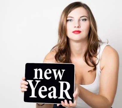 New year written on virtual screen. beautiful woman with bare shoulders holding Stock-Fotos