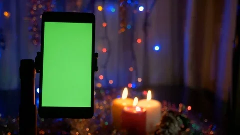 New Year's background, in the foreground a smartphone with a green screen. A Video stock 82795846