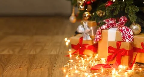 New Year's background with space for a copy, garlands, gifts, blurred lights Stock Photos
