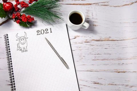 New Year's Composition 2021. Notebook with a pen and a cup of coffee on a light Stock Photos