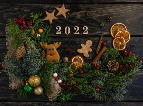 New Year's composition 2022, pine cones, tree, gingerbread, gifts. Flat lay Stock Photos
