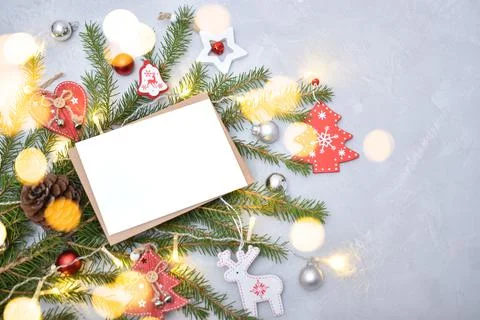 New Year's composition of a kraft envelope and festive decor with lights. Stock Photos
