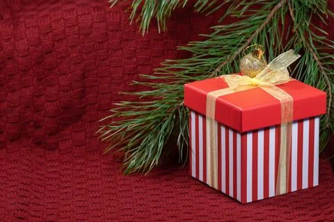 New Year's composition with a pine branch, a red gift box and Christmas decor Stock Photos