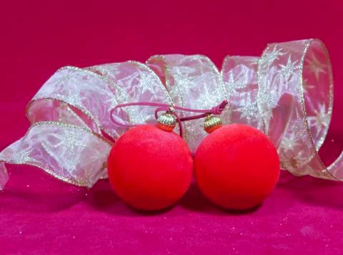 New Year's composition on a red background - ball and ribbon. Used toning of  Stock Photos
