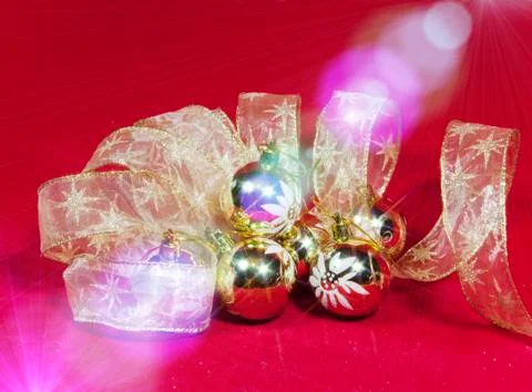 New Year's composition on a red background - ball and ribbon Stock Photos