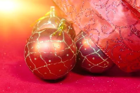 New Year's composition on a red background - ball and ribbon Stock Photos
