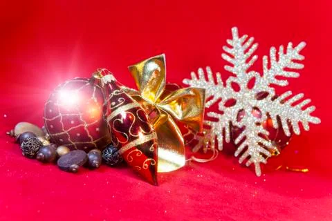 New Year's composition on a red background - ball and ribbon Stock Photos