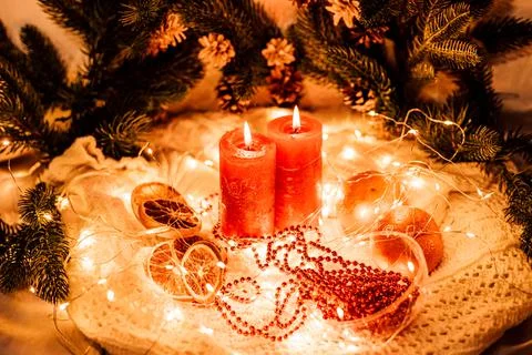 New Year's composition red candles, garlands, branches of the Christmas tree Stock Photos