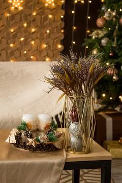 New Year's composition on the table. Cones, candles, spruce branches, bouquet Stock Photos