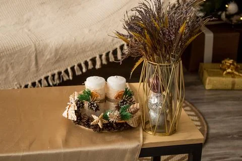 New Year's composition on the table. Cones, candles, spruce branches, bouquet Stock Photos