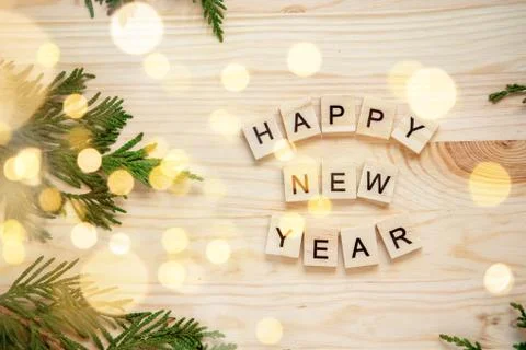 New Year's composition. Thuja branches on a wooden background and blurred bok Stock Photos