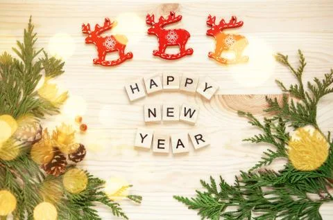 New Year's composition. Thuja branches on a wooden background and blurred bok Stock Photos