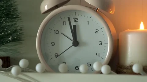 New Year's decor. Clock with hands at twelve o'clock, candles, christmas tree Stock Footage 139645563