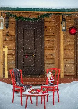 New Year's decorations with a red table and chairs in front of the house Stock Photos