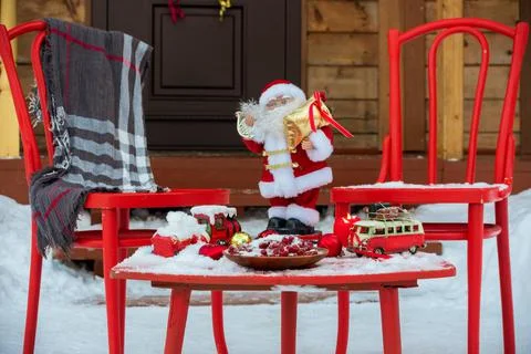 New Year's decorations with a red table and chairs in front of the house Stock Photos