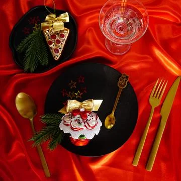 New Year's desserts. Creative table setting with Christmas tree toys. Stock Photos