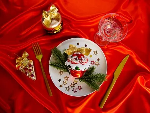 New Year's desserts. Creative table setting with Christmas tree toys. Stock Photos