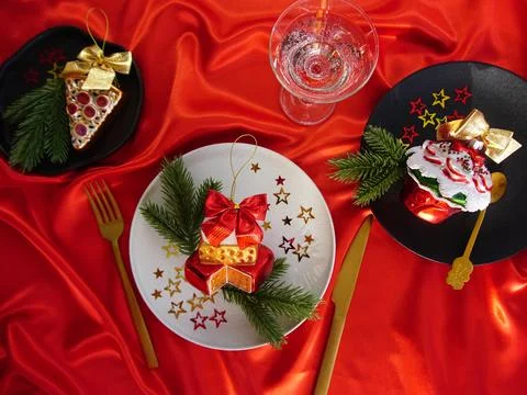 New Year's desserts. Creative table setting with Christmas tree toys. Stock Photos